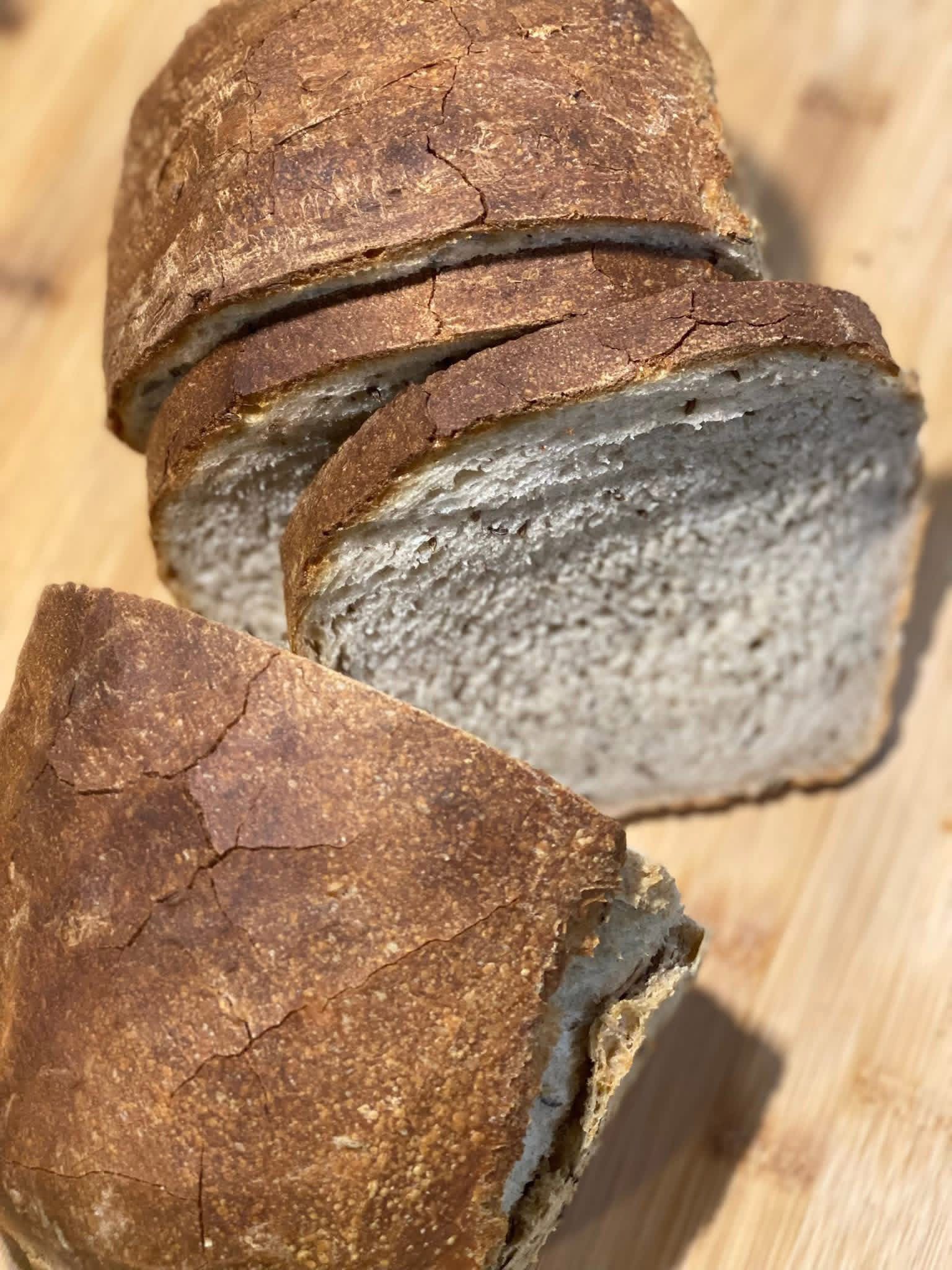 Sliced sourdough sandwich loaf with a tight, tender crumb